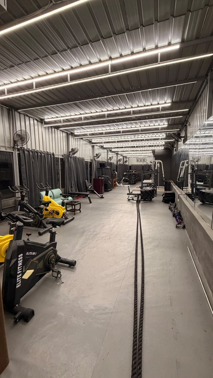 Spacious functional training floor with battle ropes at Revive Fitnes